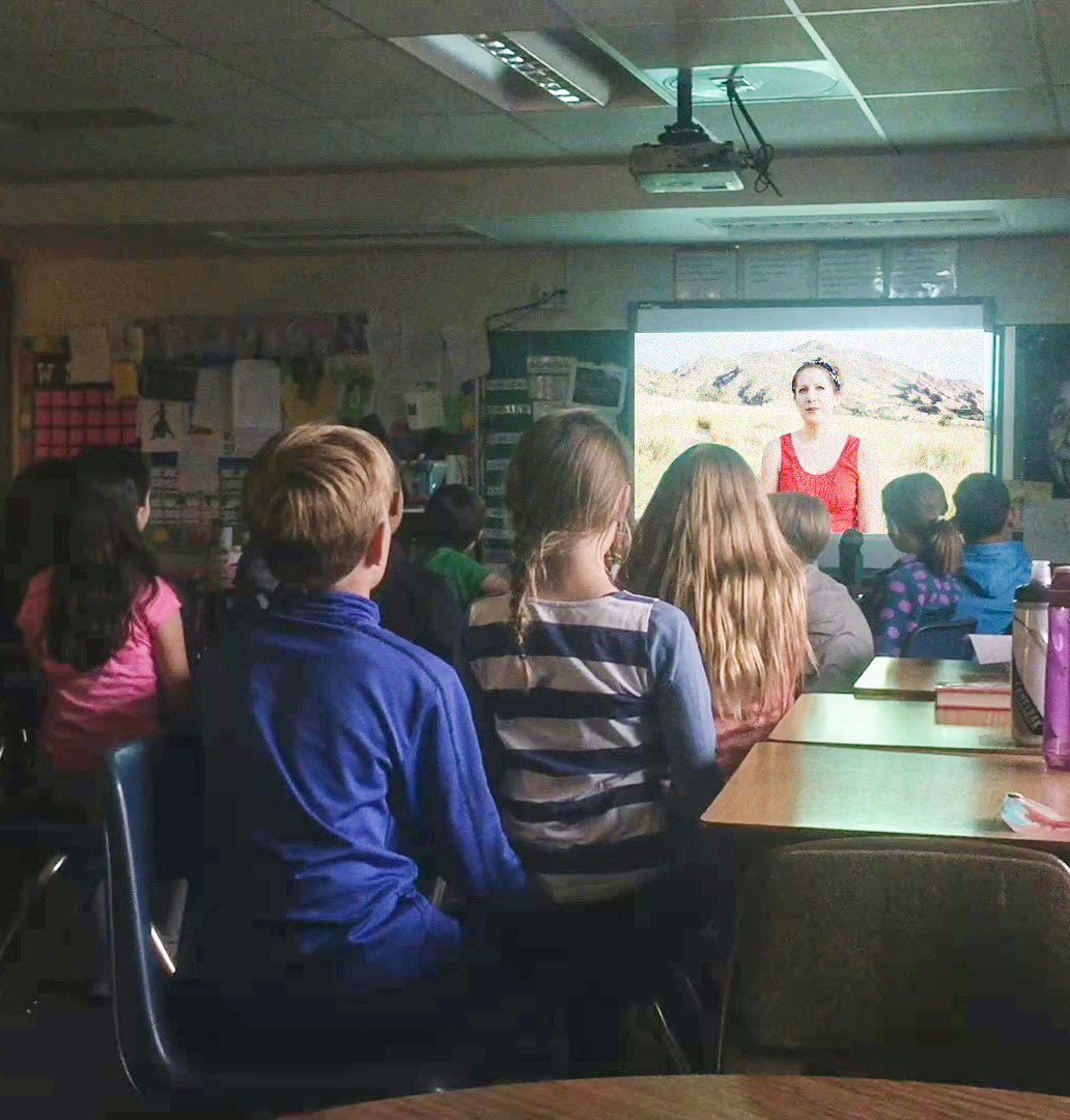 Kids in classroom watching one of the Roots Up videos